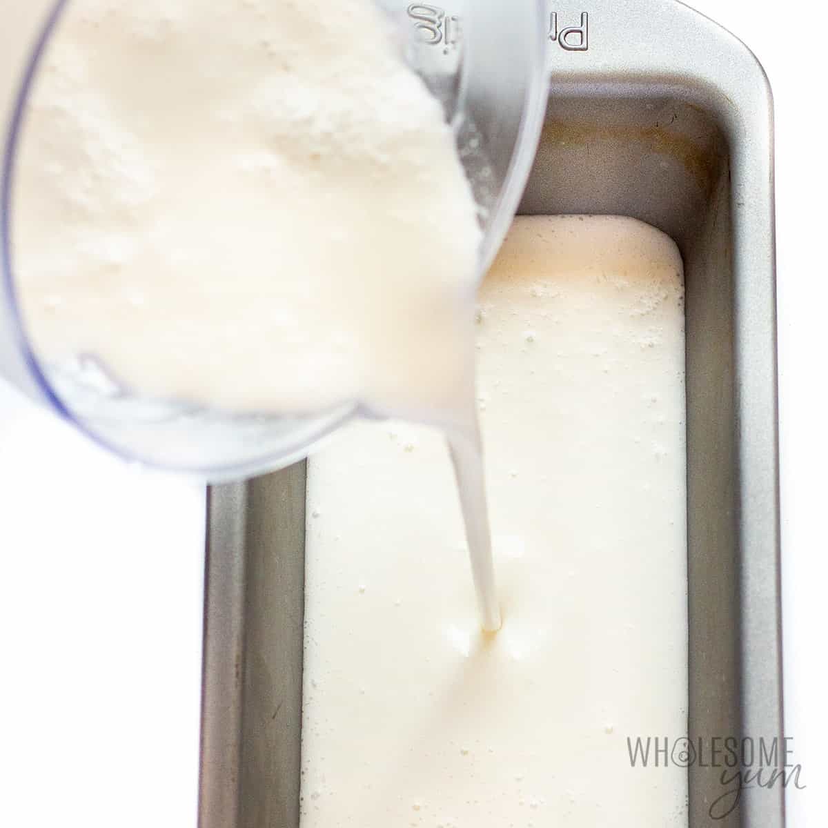 Ice cream mixture pouring into loaf pan.