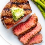 Perfect grilled steak recipe partially sliced.