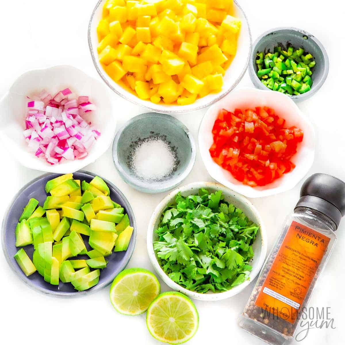 Pineapple salsa ingredients in bowls.