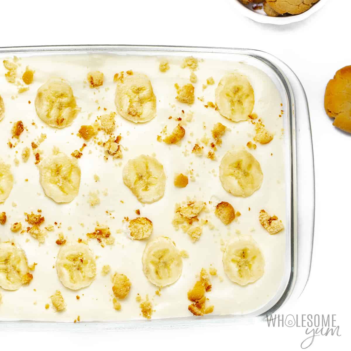 Fully assembled sugar-free banana pudding with slices of banana and cookie crumbs on top..