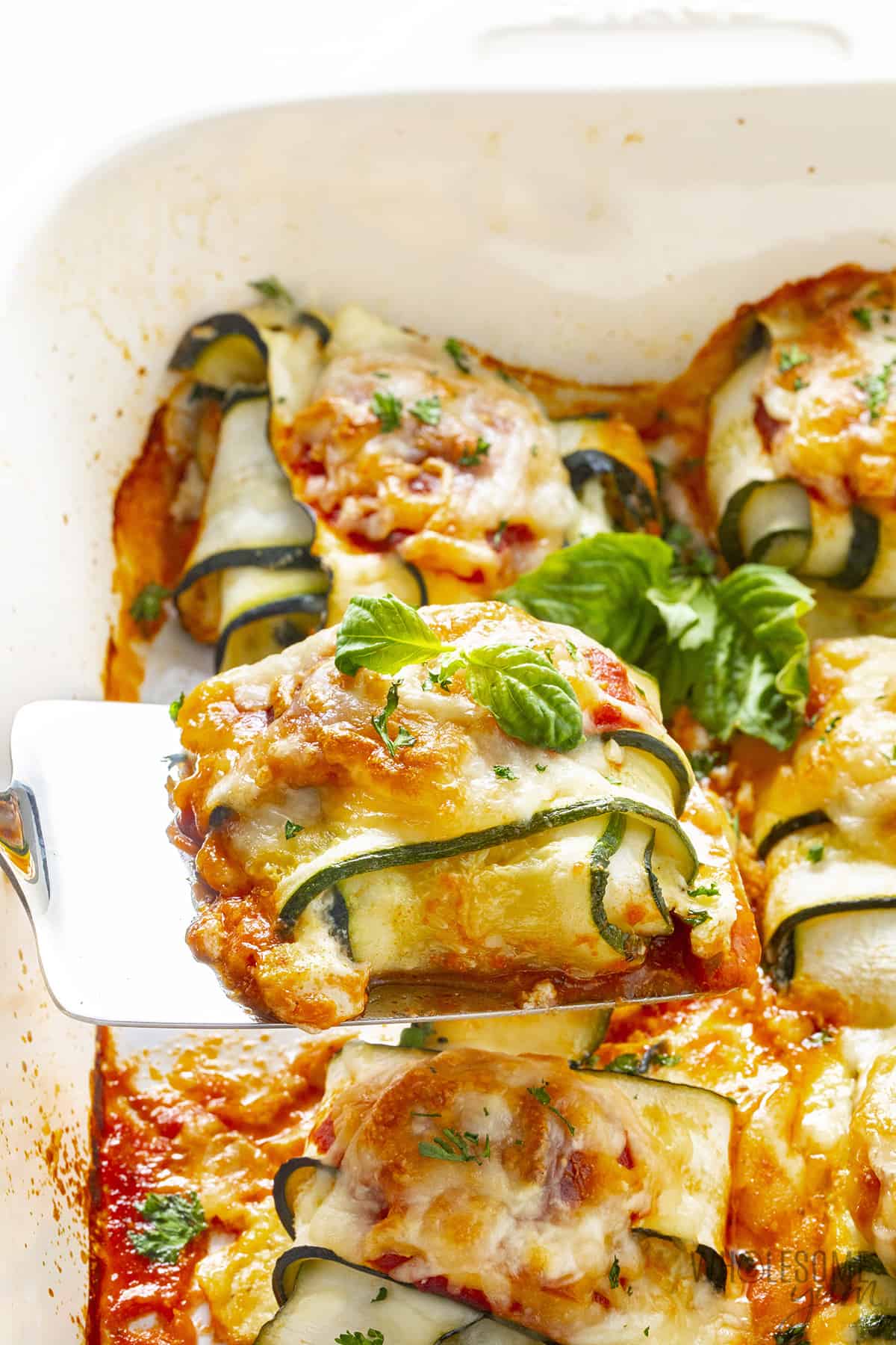 Remove zucchini ravioli from baking sheet with spatula.