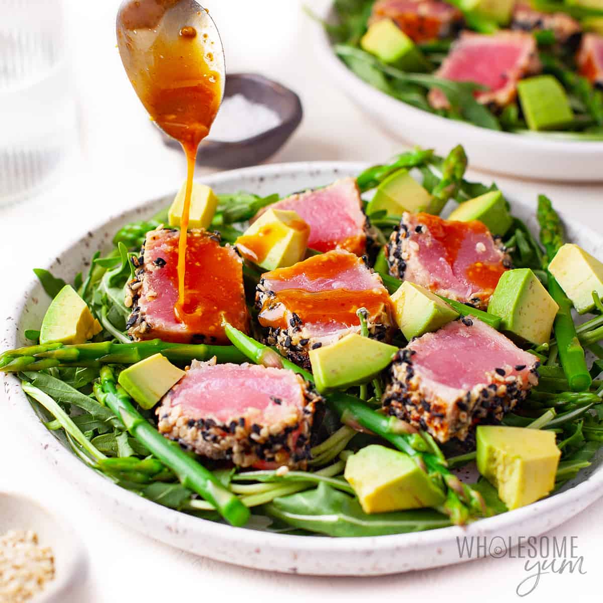 Ahi tuna salad recipe with dressing being drizzled.