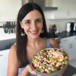 Maya holding a bowl of chef salad.