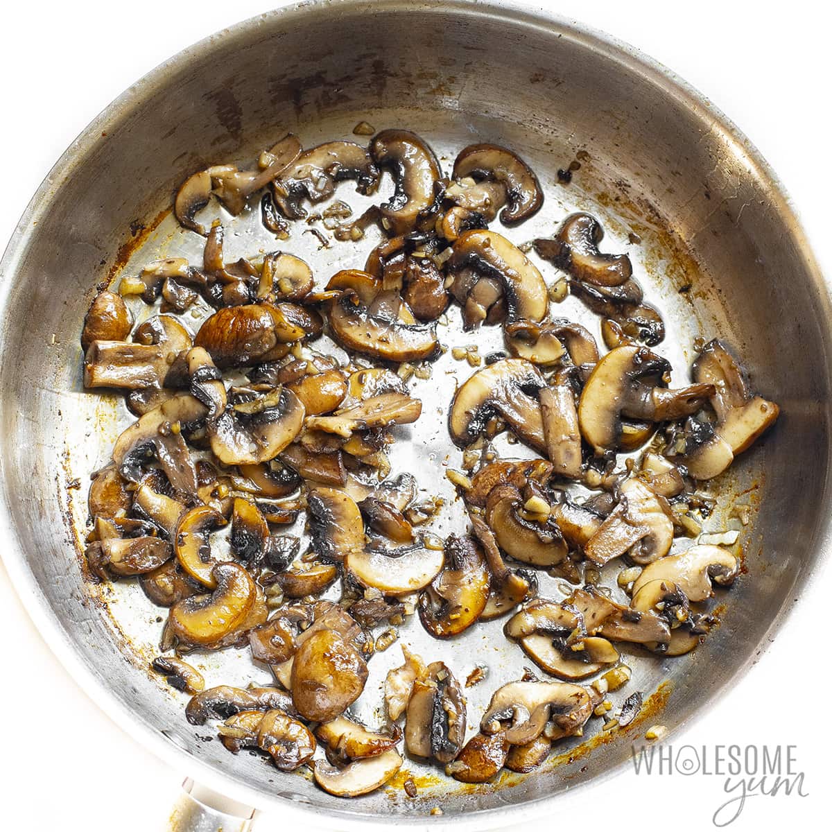 Mushrooms cooking in a pan.