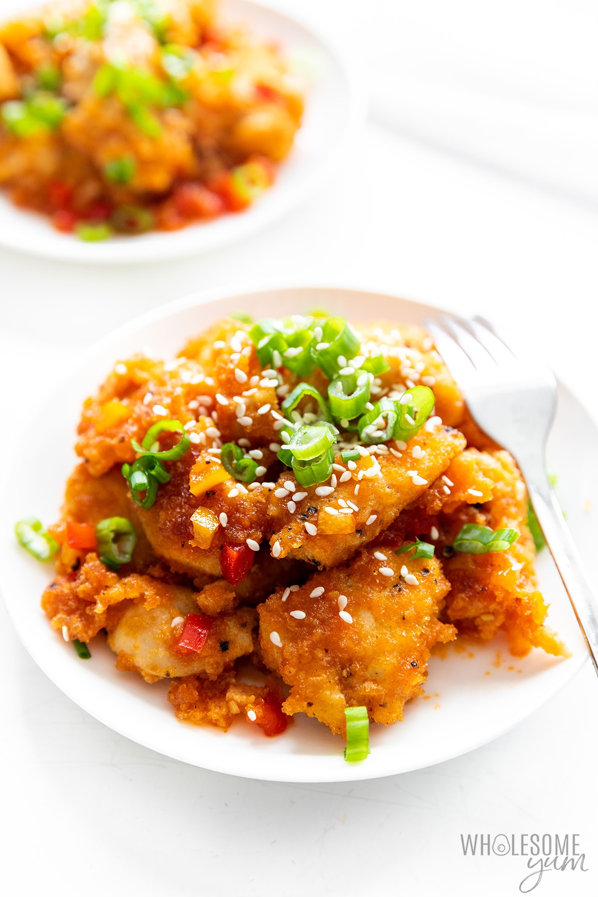 Healthy sweet and sour chicken on plates.