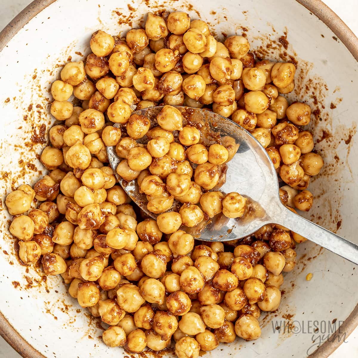 Chickpeas mixed with spices in a bowl.
