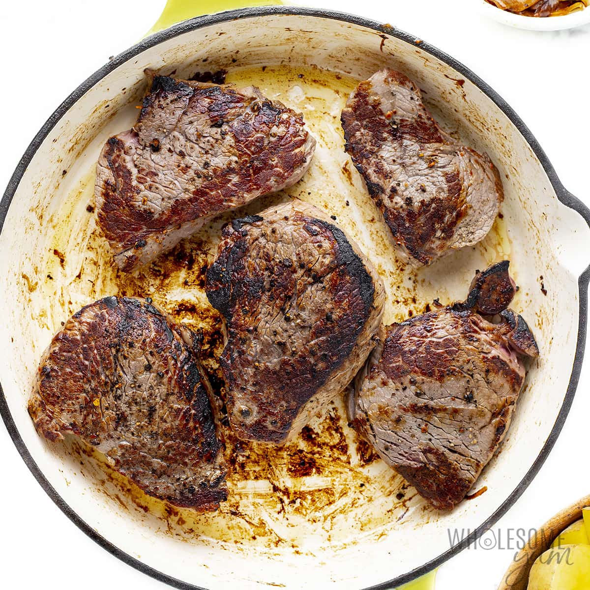 Steaks seared in pan.