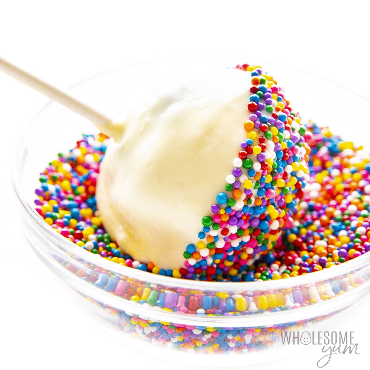 Cake pops with dip and sprinkles.