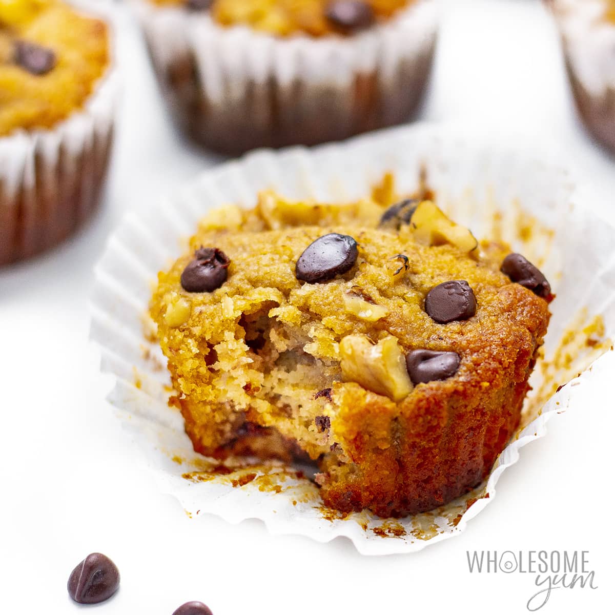 Healthy banana muffins with one unwrapped.