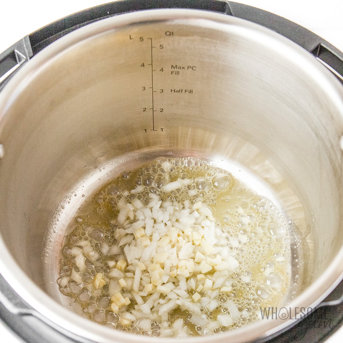 Butter garlic and onions in the Instant Pot.