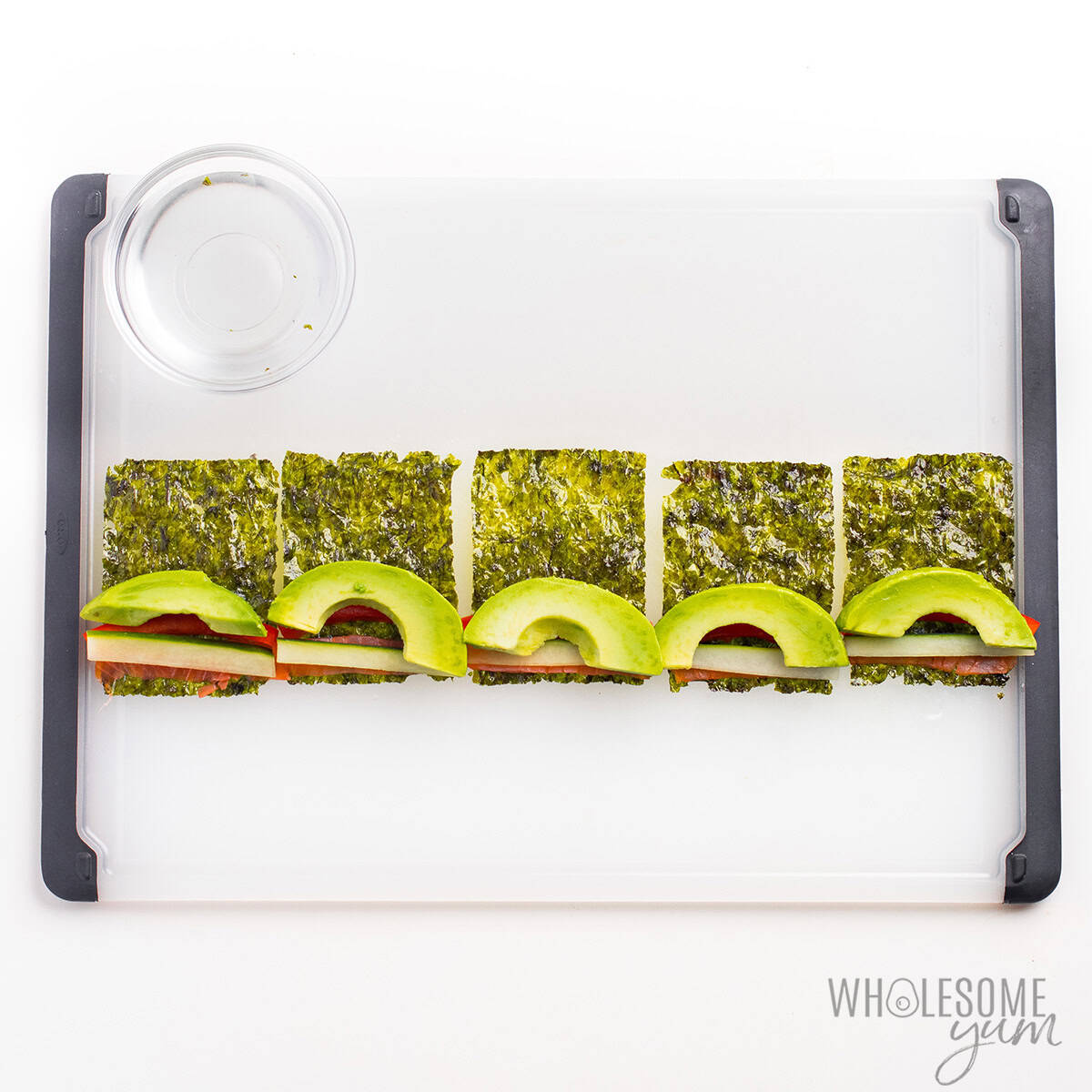 Seaweed snack sheets topped with smoked salmon, cucumber, bell pepper, and avocado.