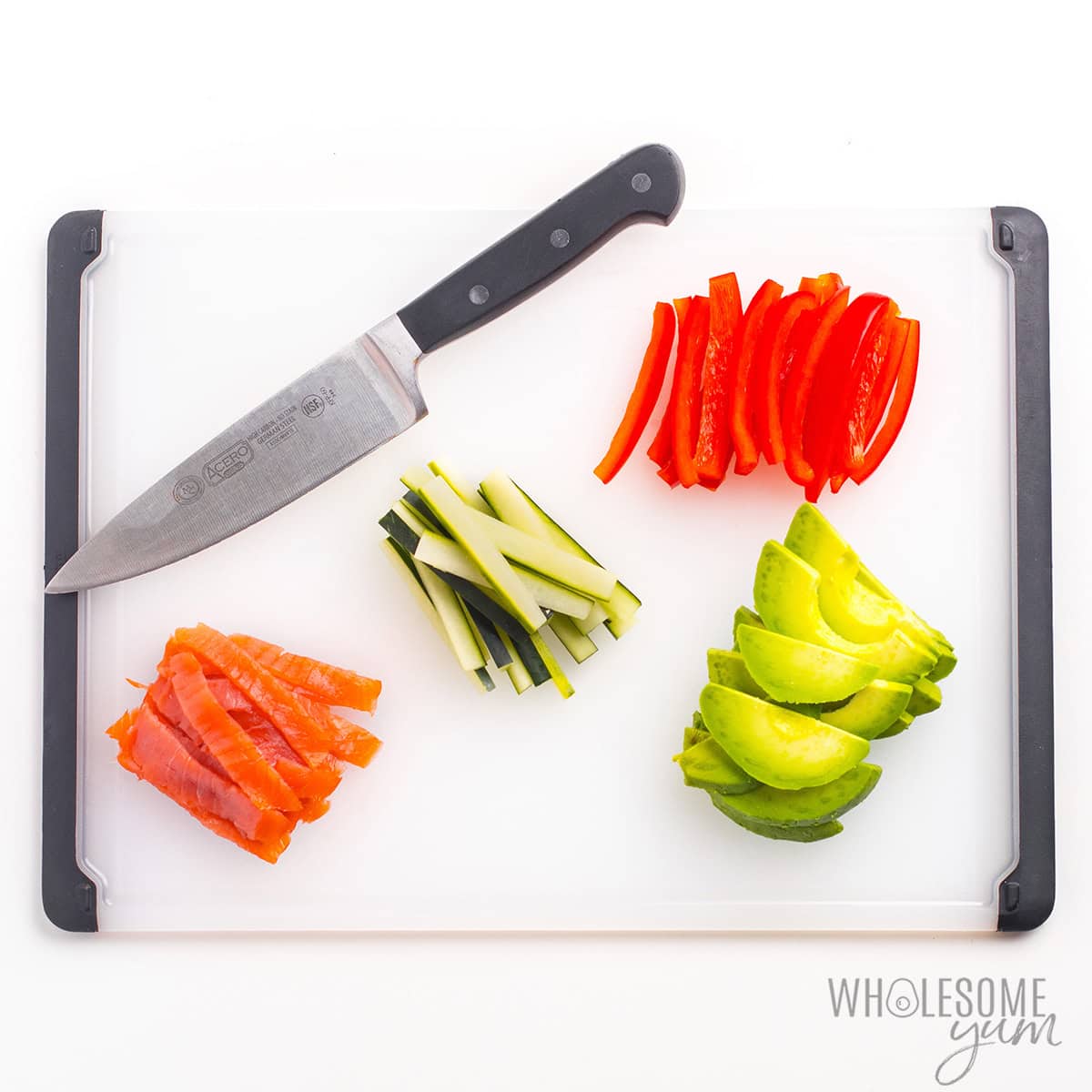 Cutting cucumber, bell pepper, smoked salmon, and avocado into thin strips.
