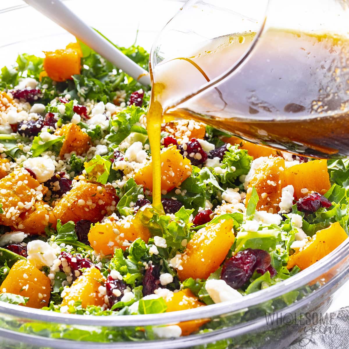 Butternut squash salad with dressing poured on top.