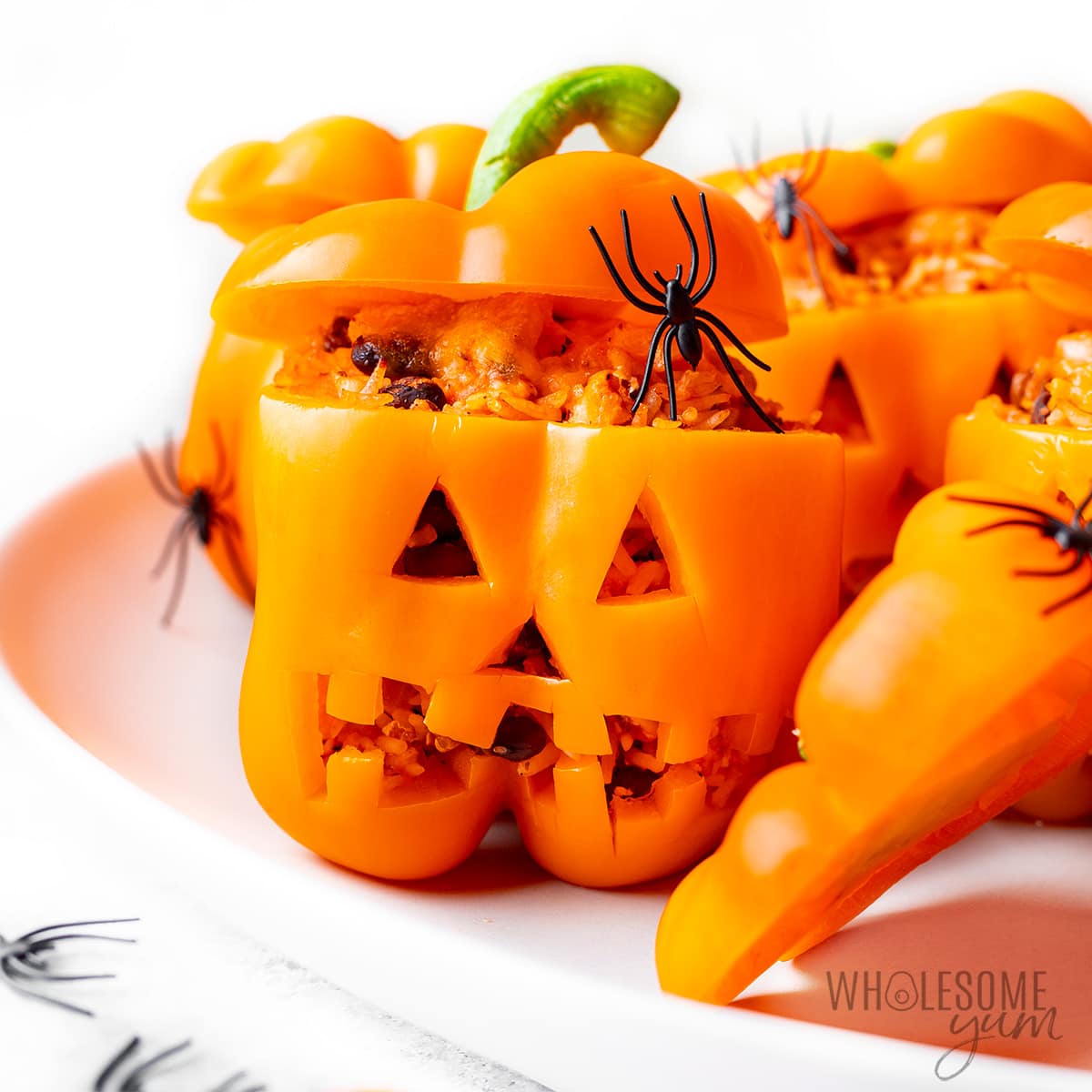 Jack-o-lantern Halloween stuffed peppers close up.