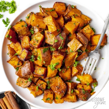Oven roasted sweet potatoes on a plate with a fork.