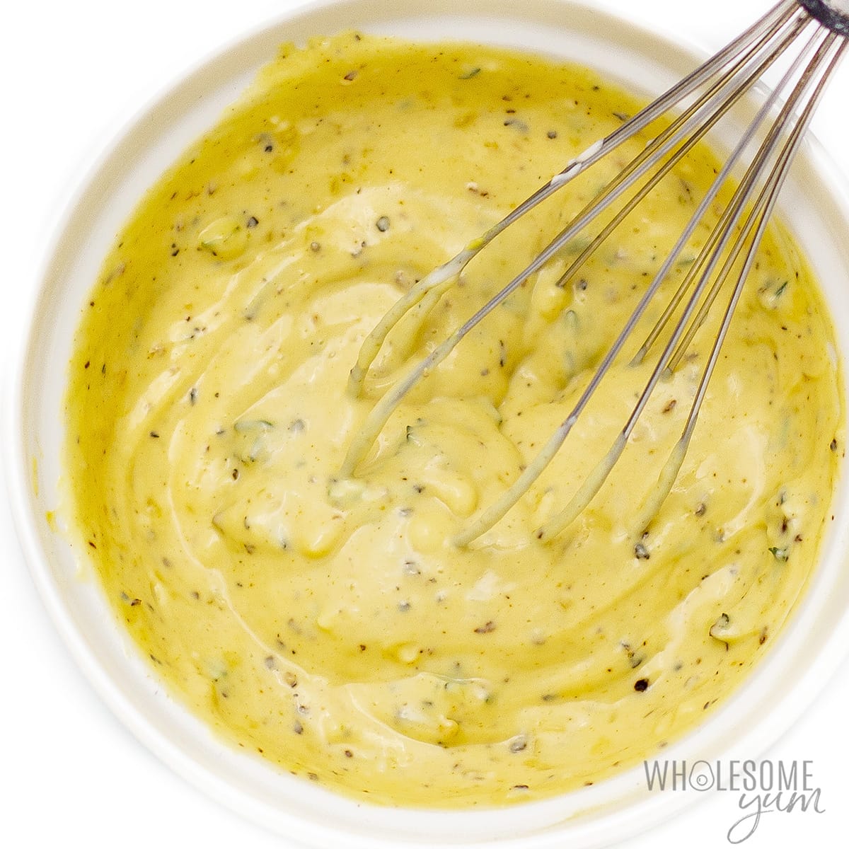 Salad dressing with whisk.