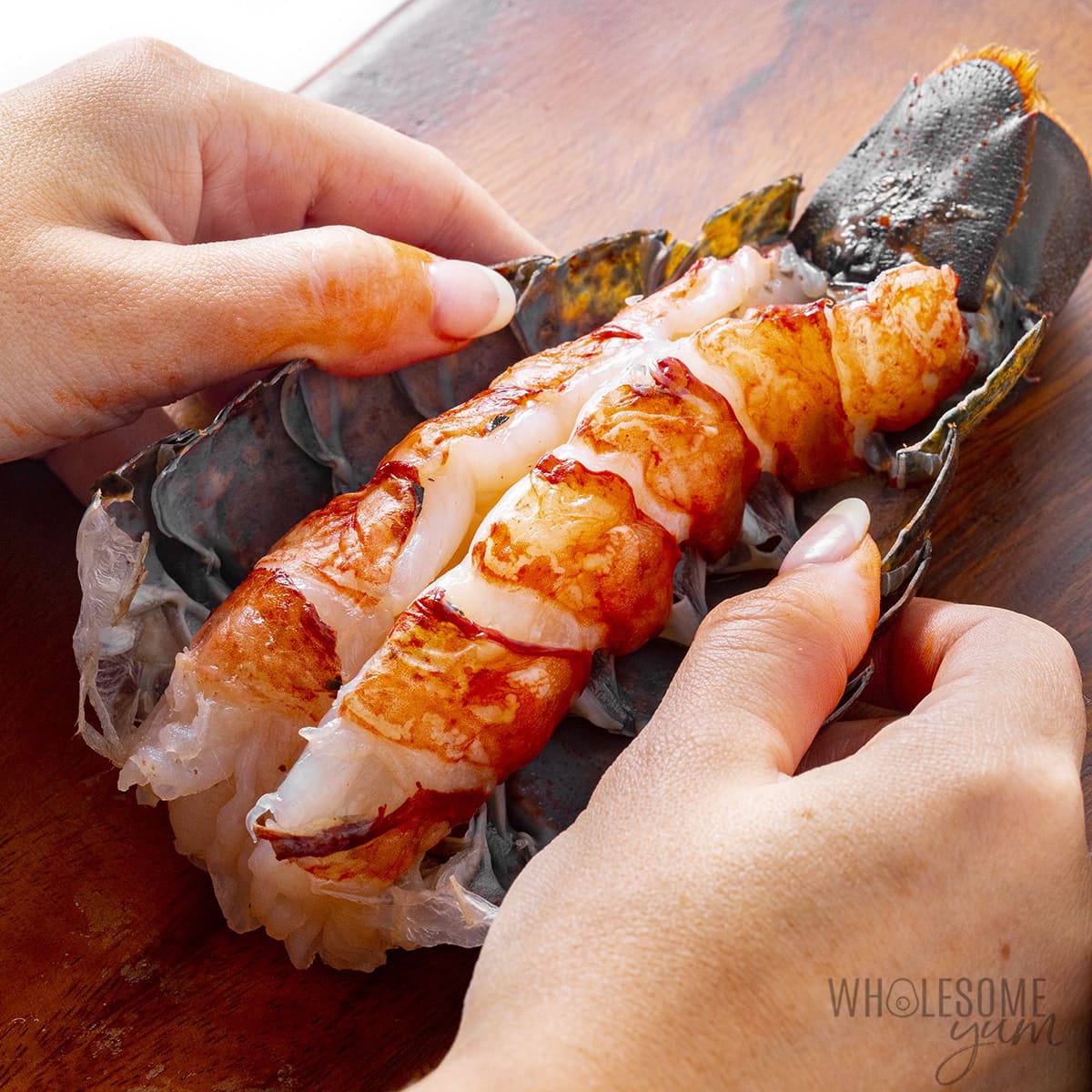 Hands spreading shell away from the meat.