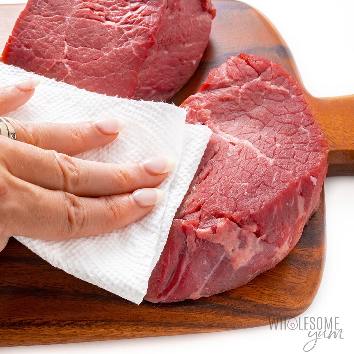 Steaks patted dry with a paper towel.
