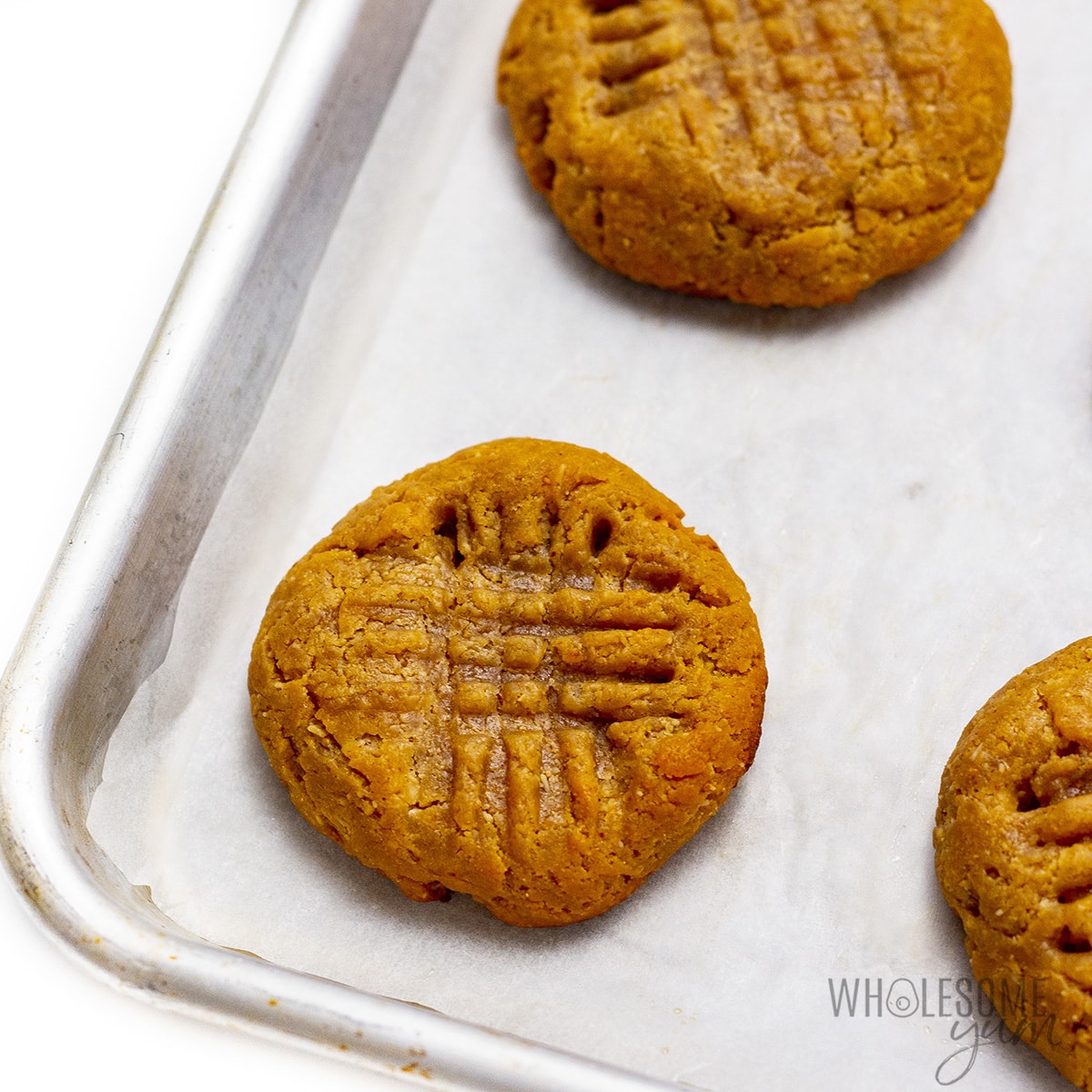 Bake almond butter cookies on a cookie sheet.