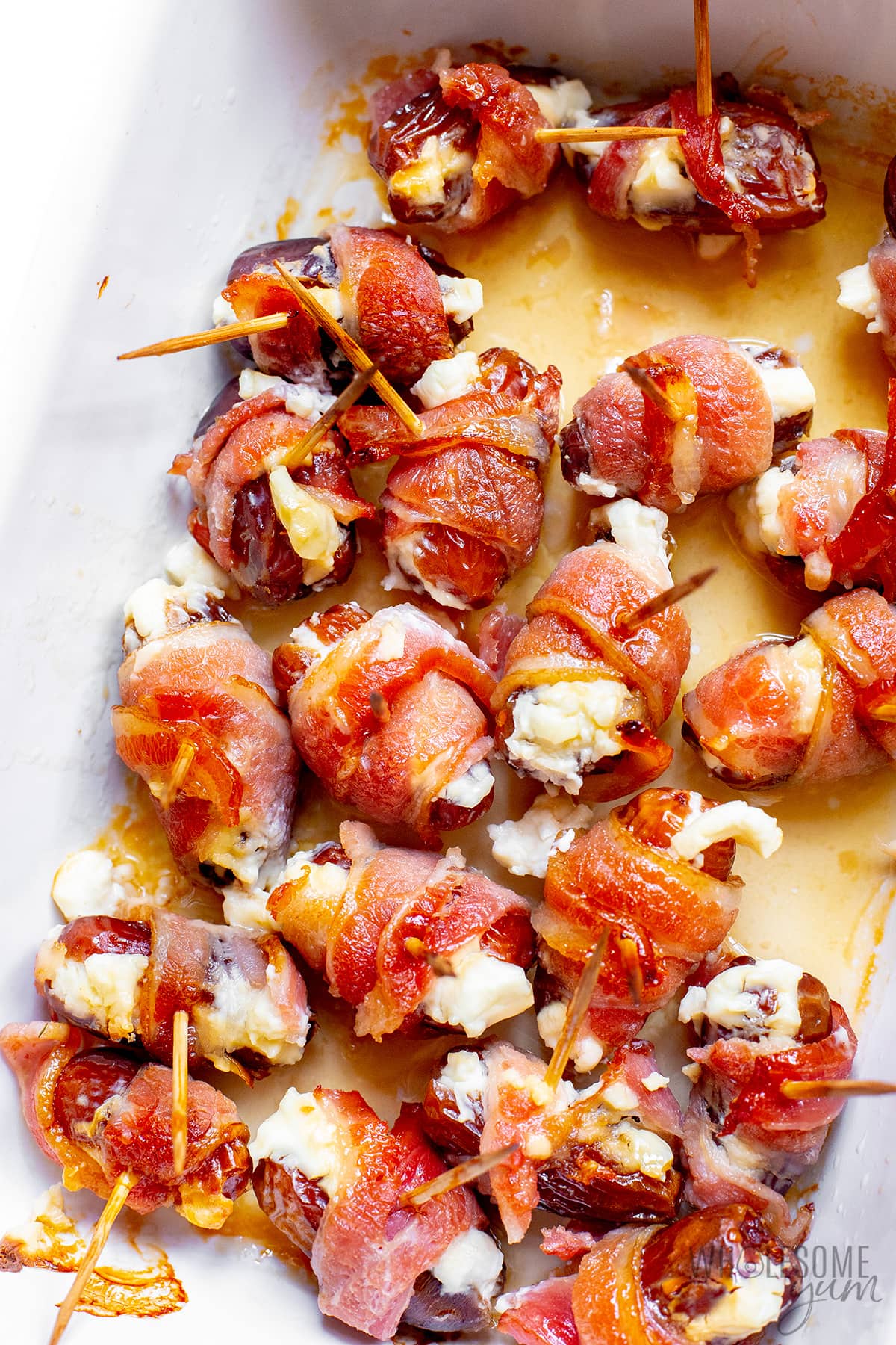 Bacon wrapped dates recipe in a baking dish.