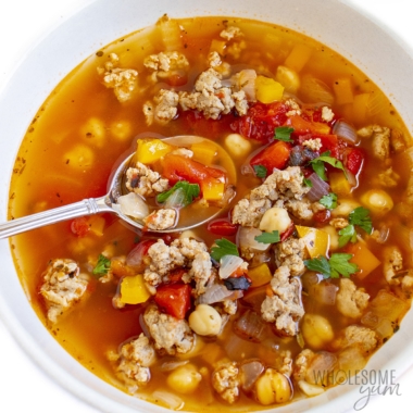 Ground turkey soup in a bowl with spoon.