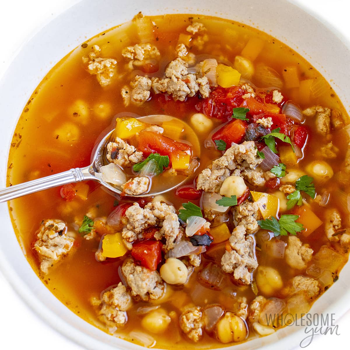 Ground turkey soup in a bowl with spoon.