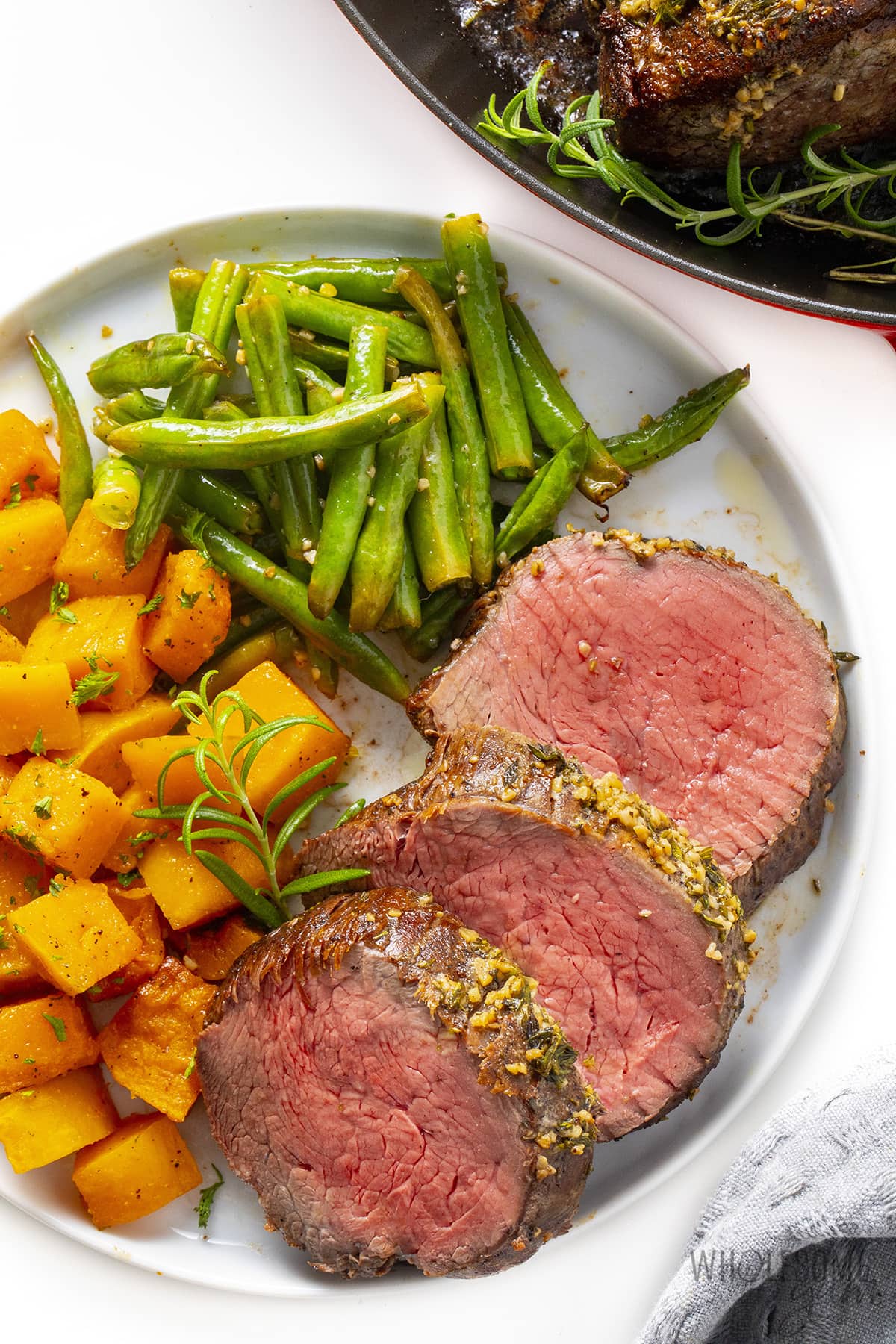 Plated beef tenderloin recipe with butternut squash and green beans.