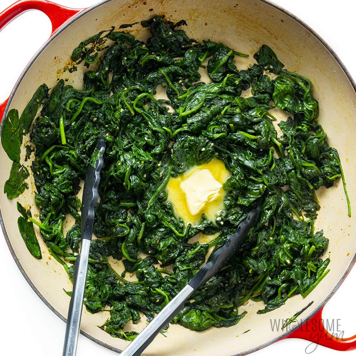 Butter added to the center of the spinach.