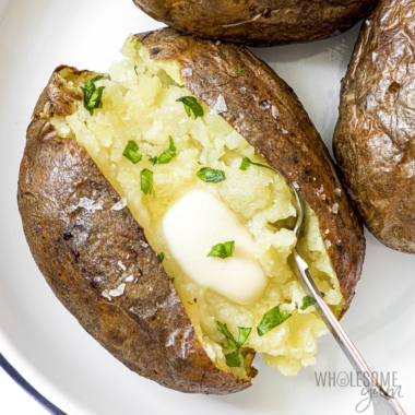 Air fryer baked potato on a plate.