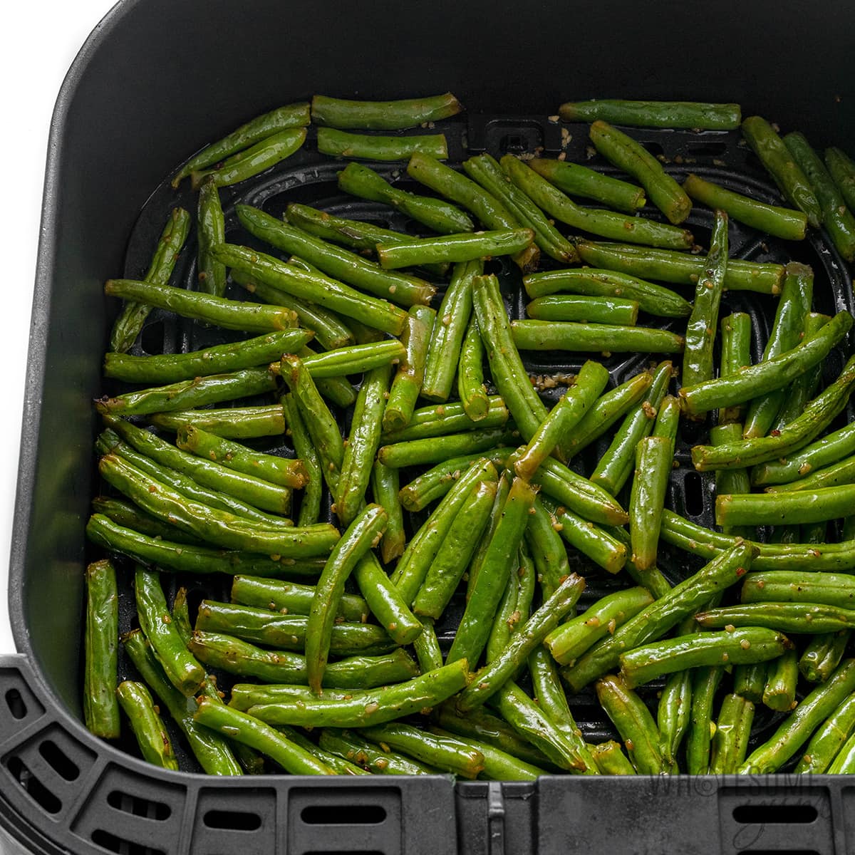 Cooked green beans in the fryer basket.