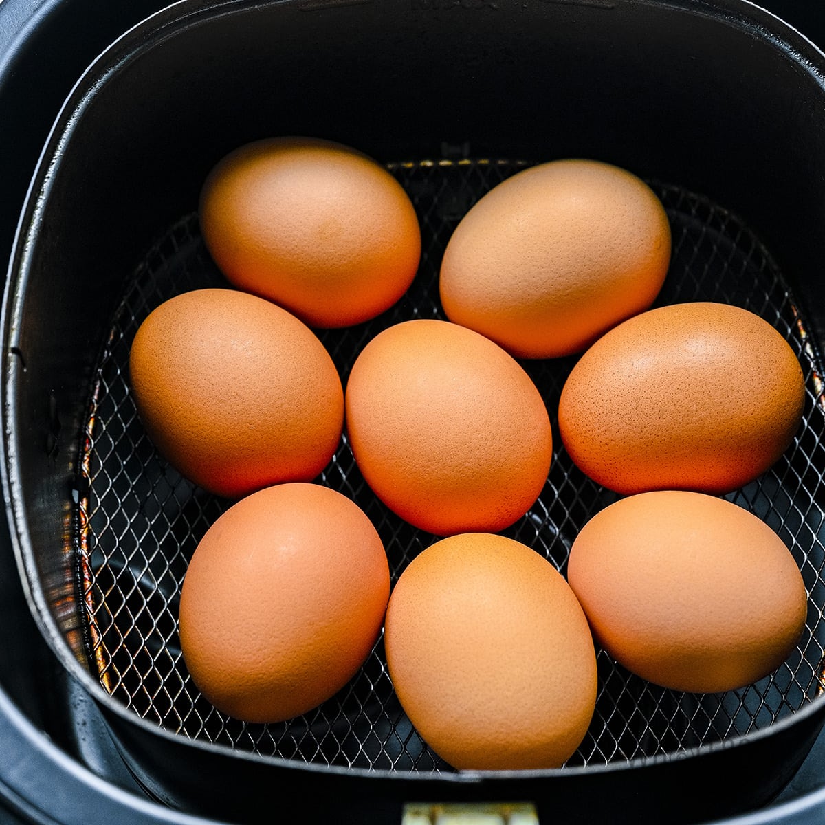 Eggs in air fryer basket.