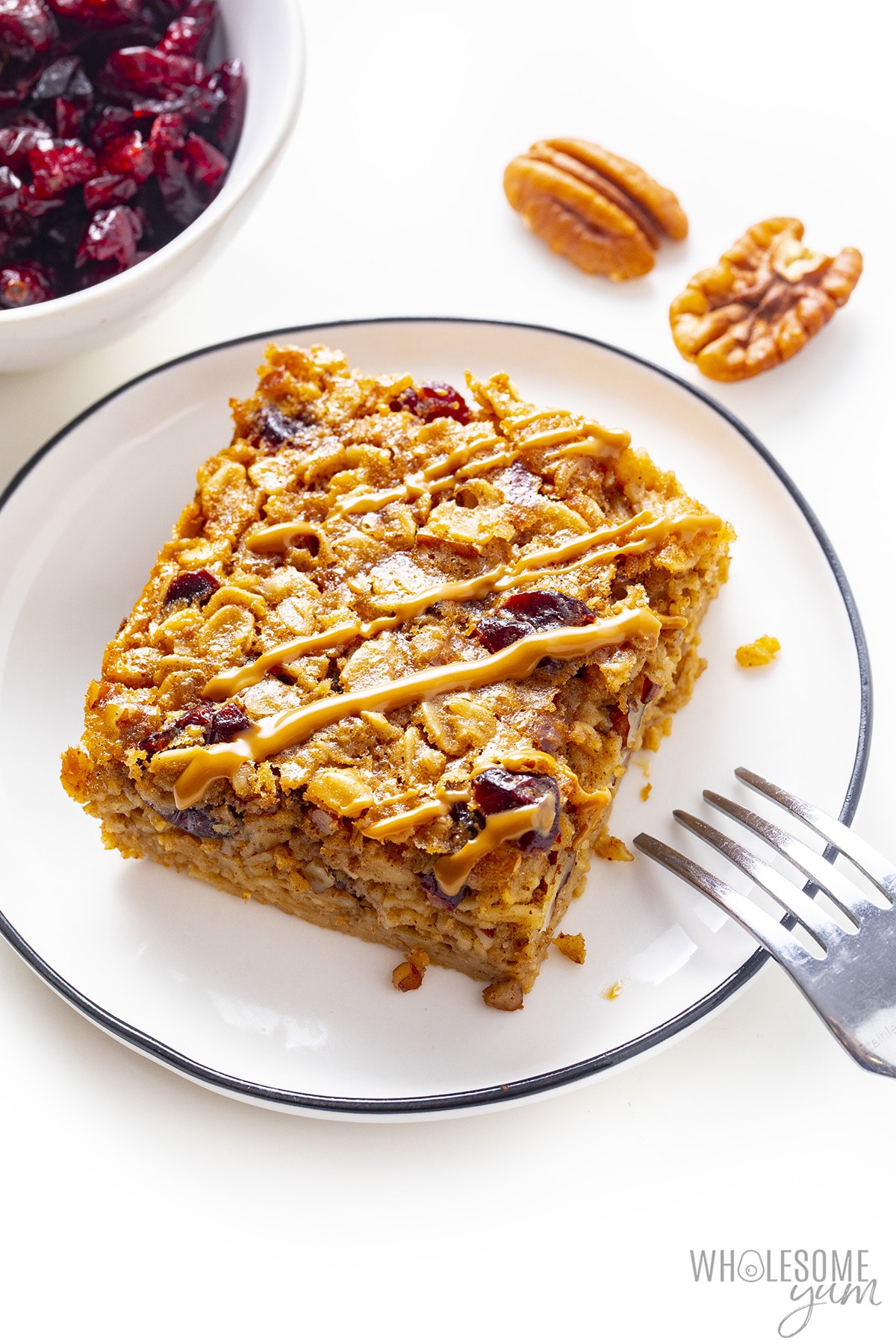Baked oatmeal square on a plate with a fork.