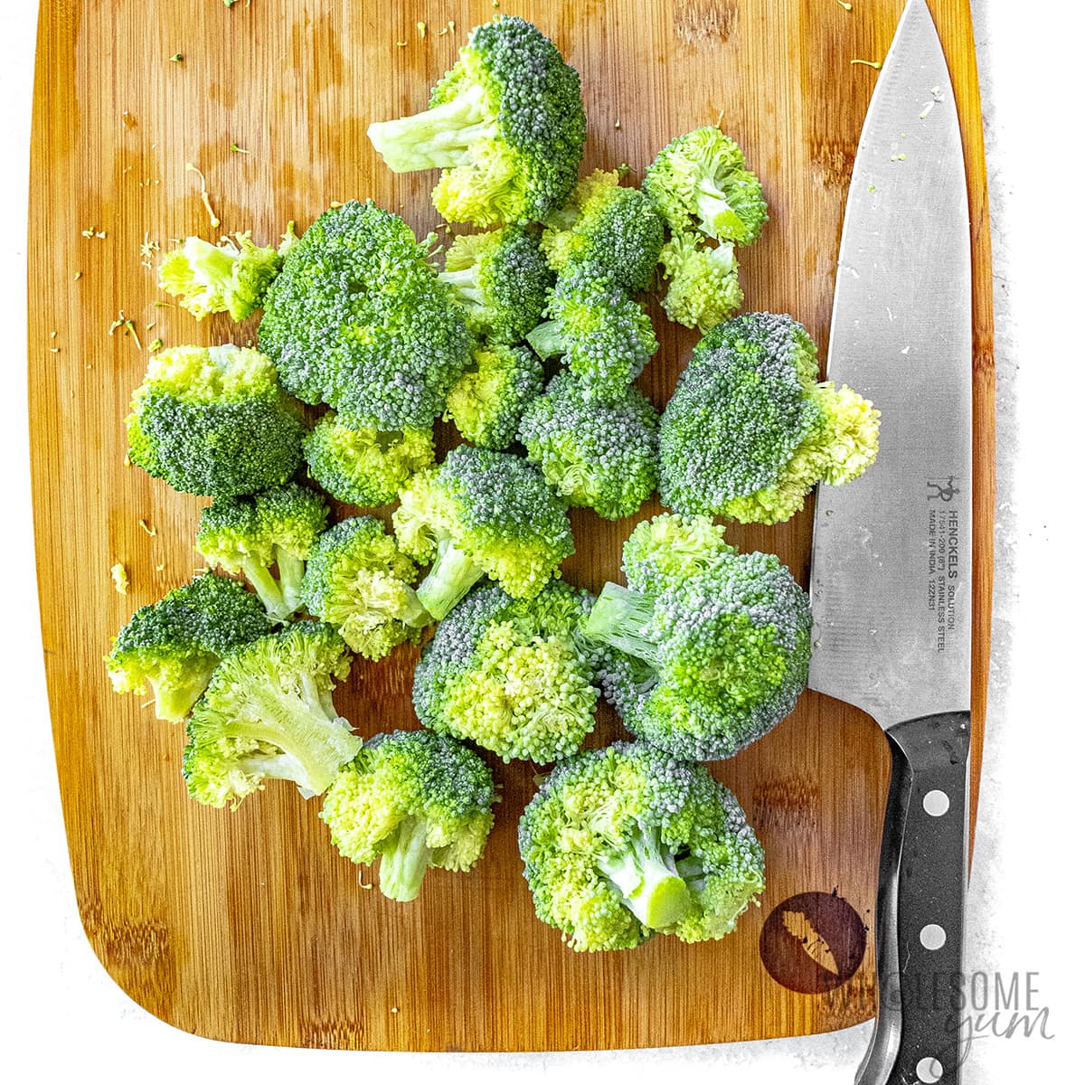 Cutting broccoli florets into similar sizes. 