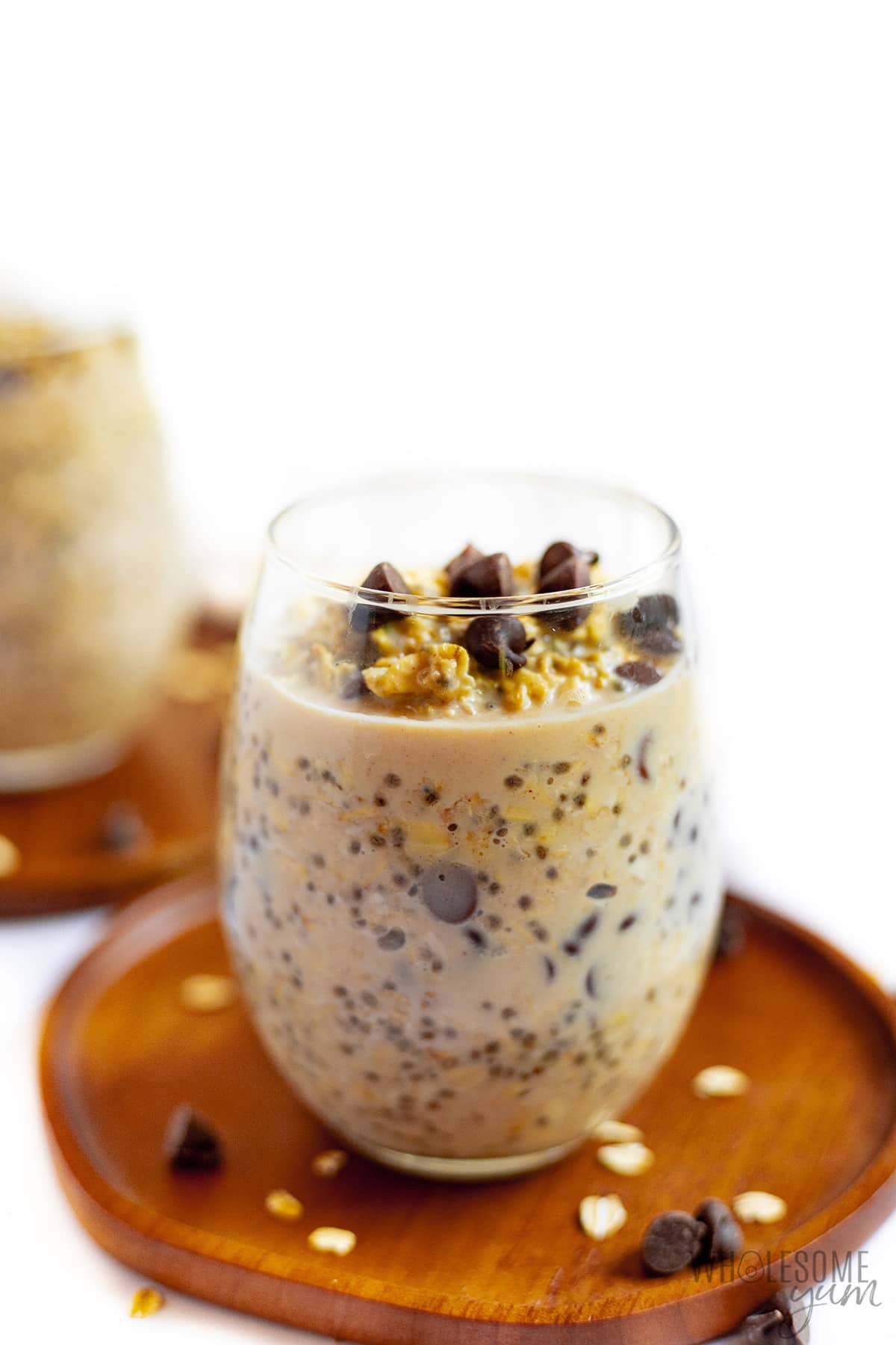 Peanut butter overnight oats in a glass on a plate. 