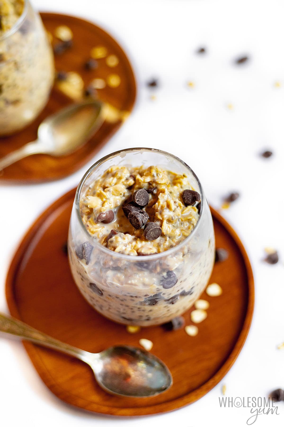 Peanut butter overnight oats in serving glass on a plate. 