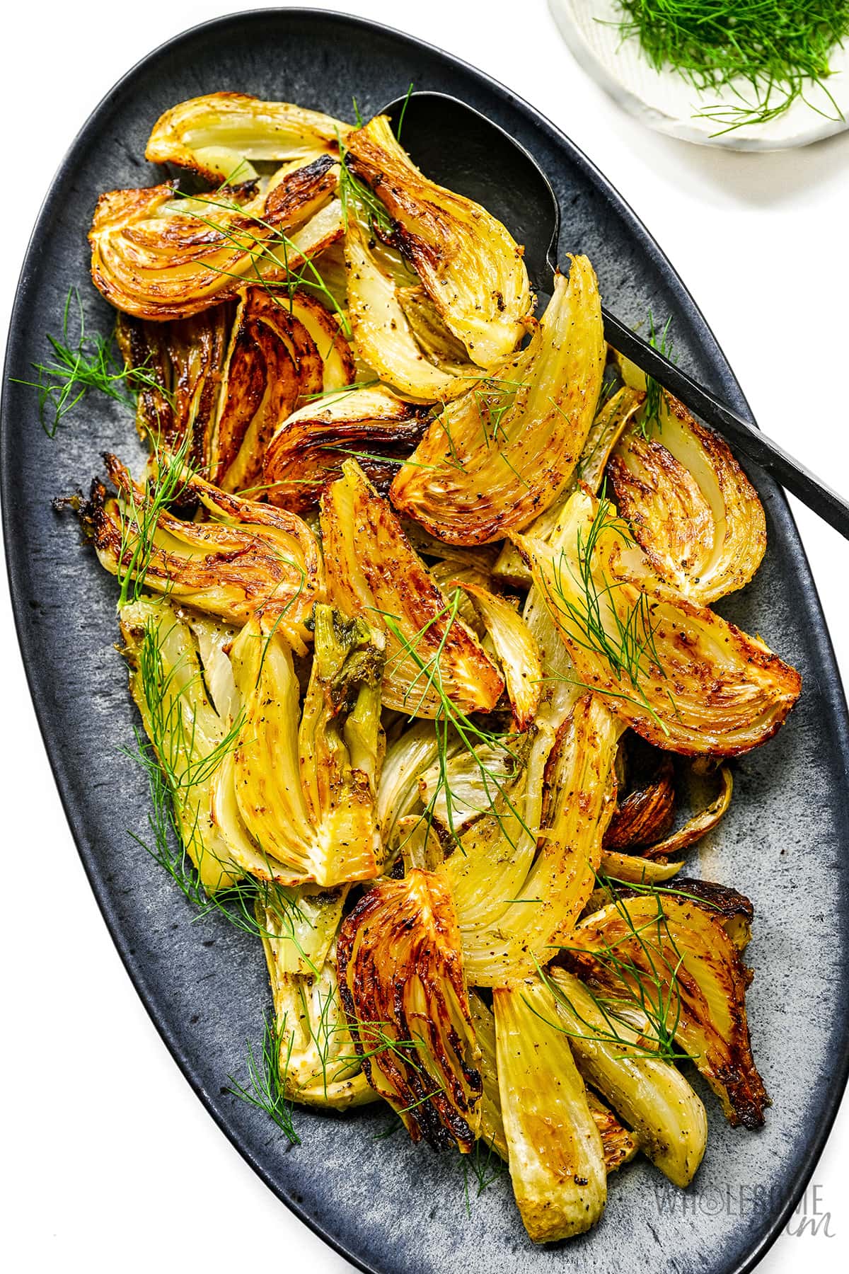Garnished roasted fennel recipe on a plate. 
