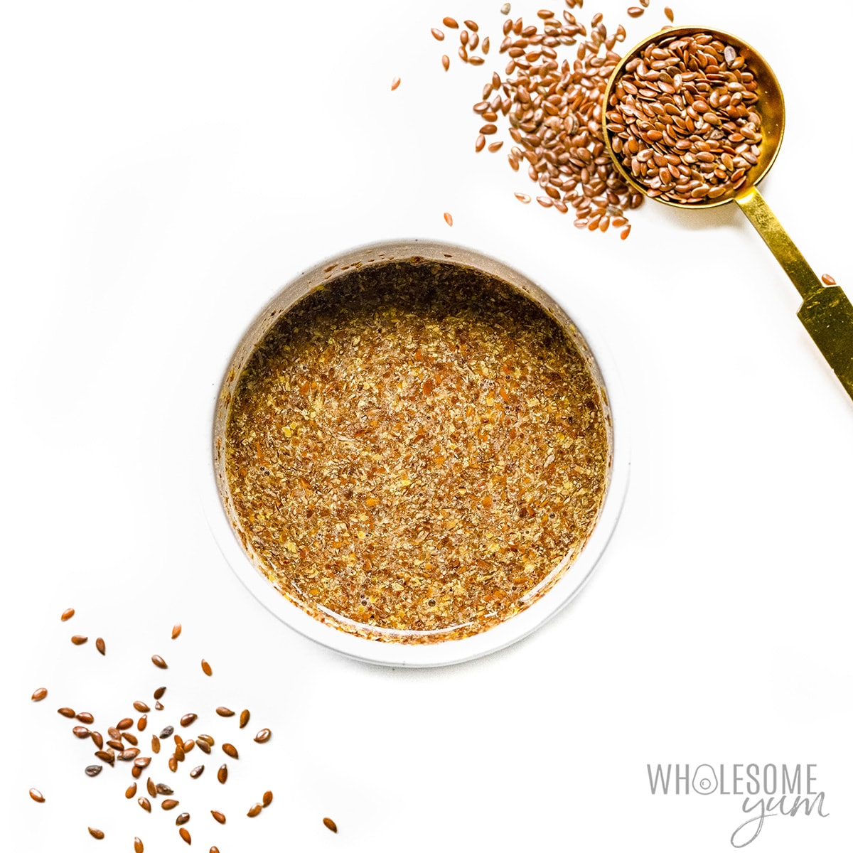 Flaxseed meal egg substitute in a bowl with measuring spoon.