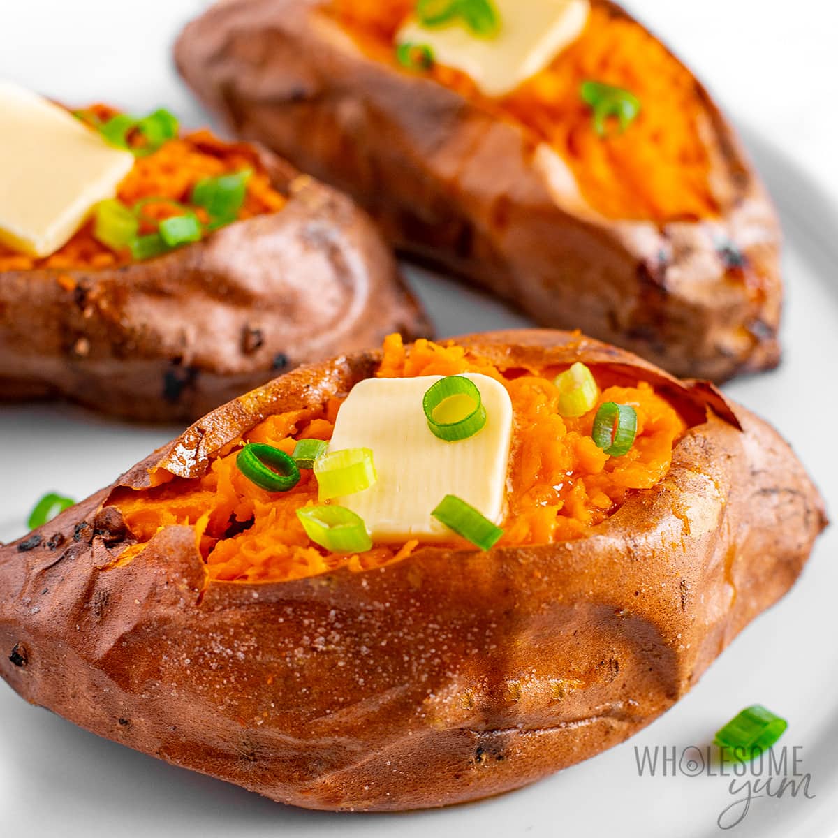 Baked sweet potato with a few more in background.