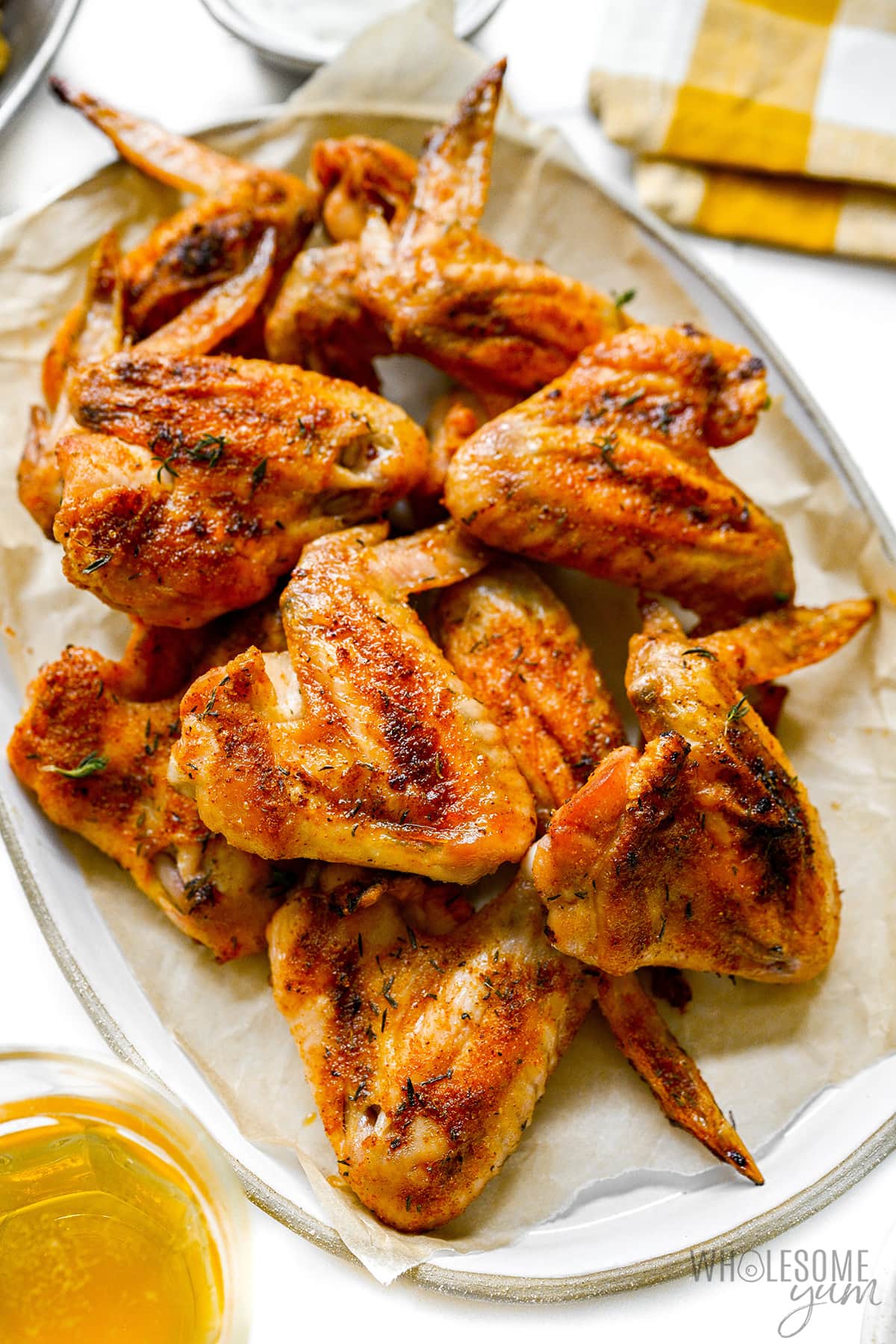 Baked whole chicken wings piled on a plate.