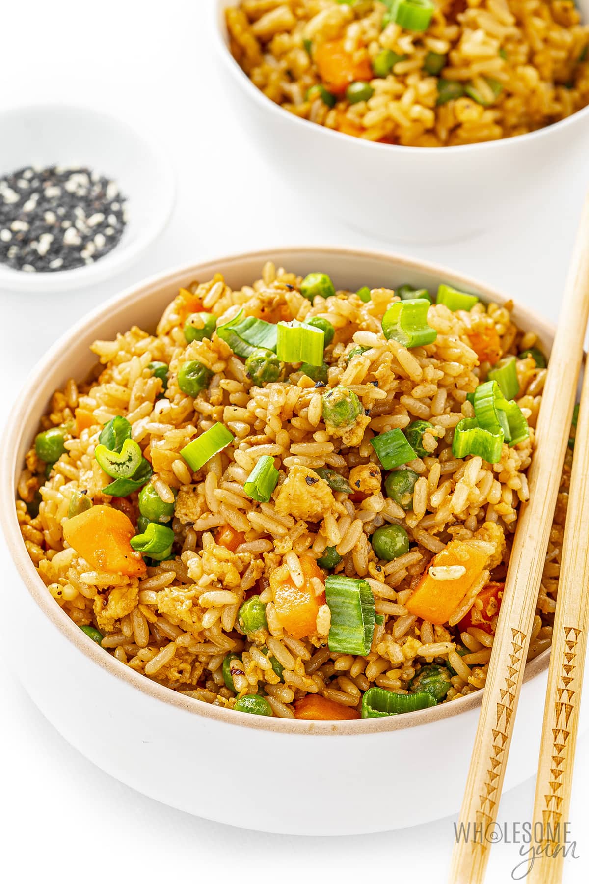 Easy fried rice in a bowl, with another bowl in background.