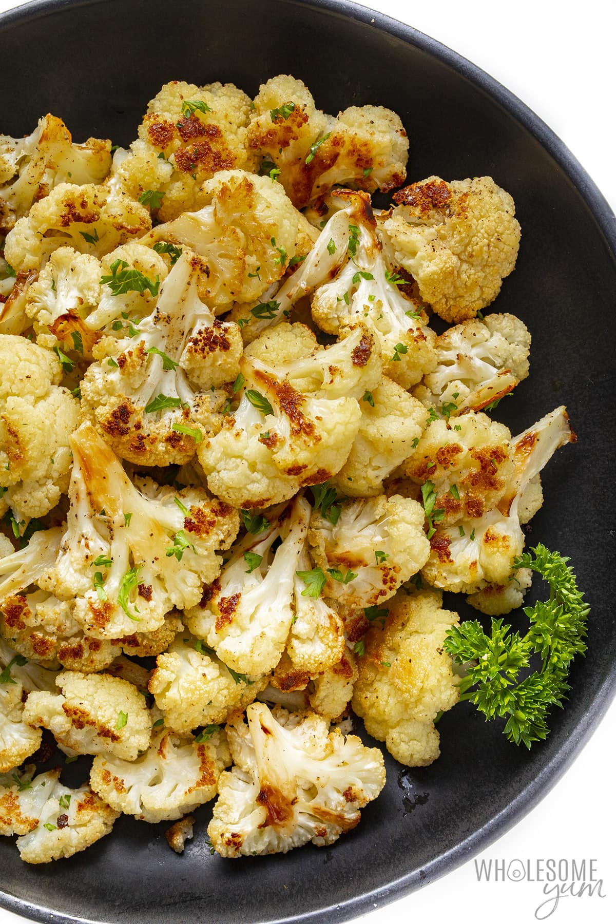 Oven roasted cauliflower in a serving bowl.
