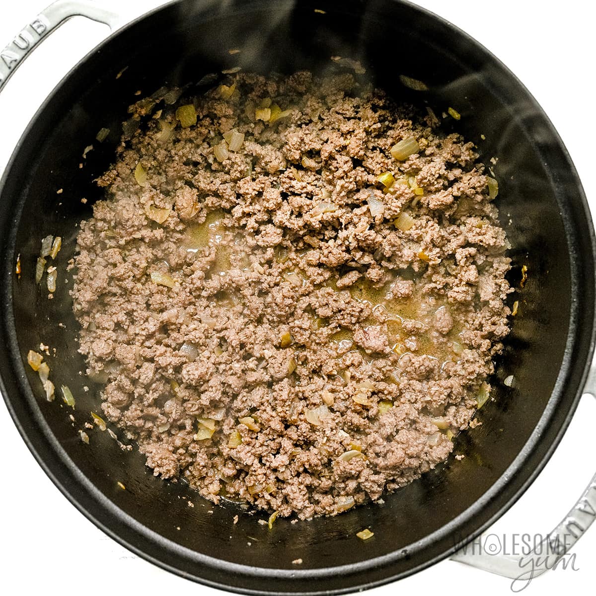 Ground beef browned in pot. 
