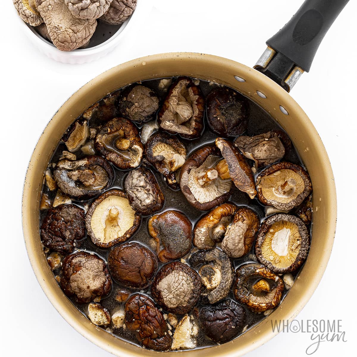Mushrooms in a pot with water simmering. 