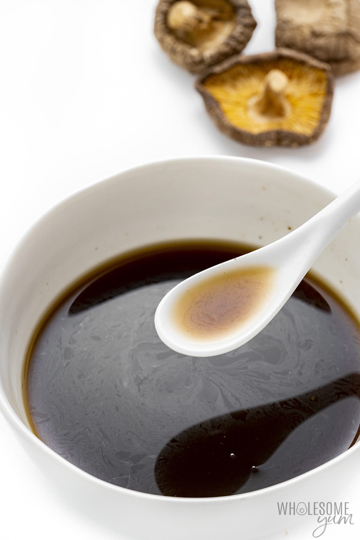 Homemade soy sauce substitute in a bowl with a spoon. 