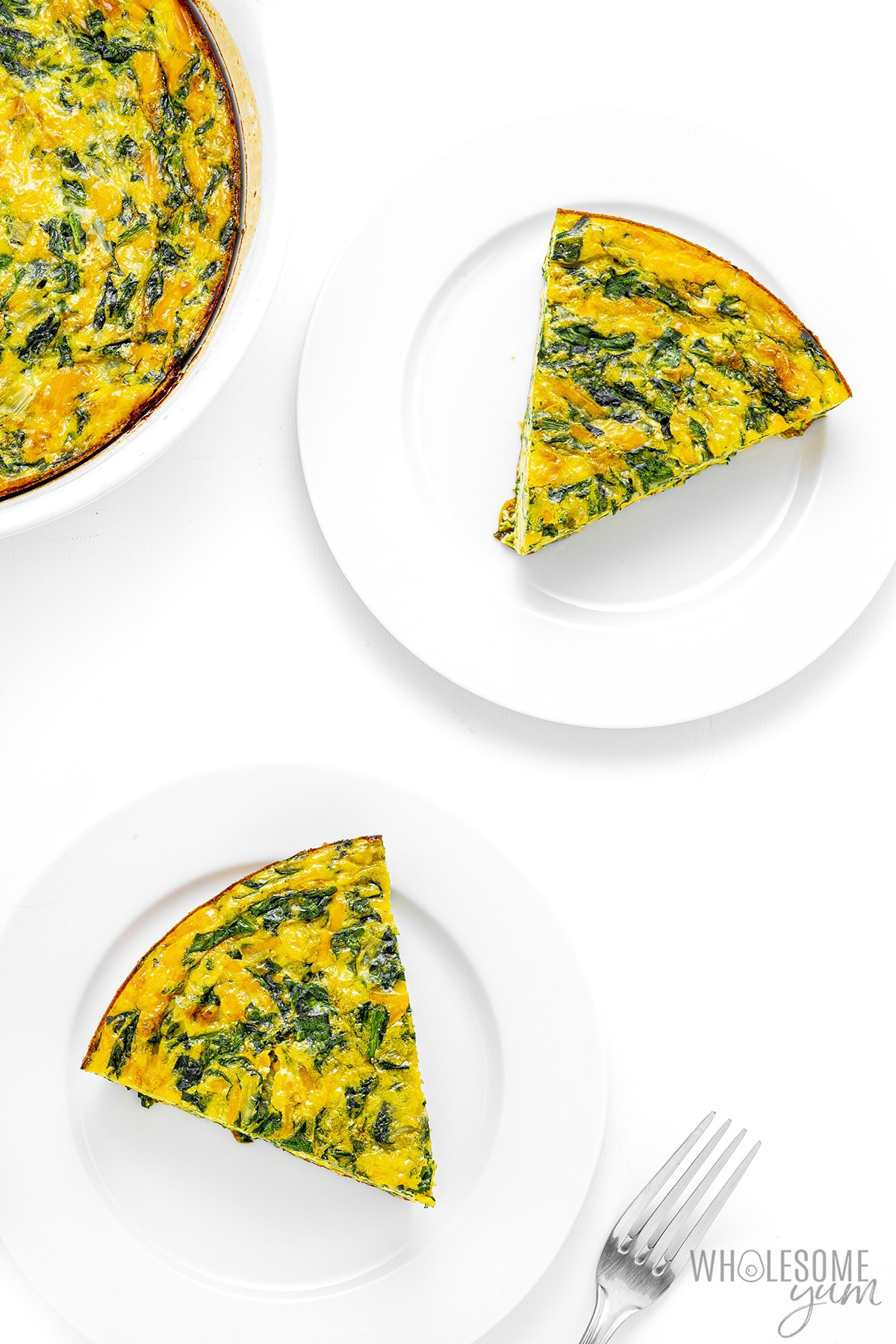 Slices of spinach quiche on plates.