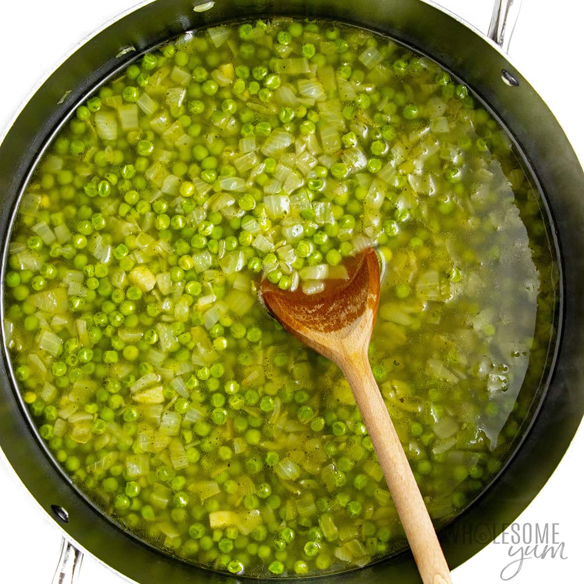 Peas and stock added to the skillet.