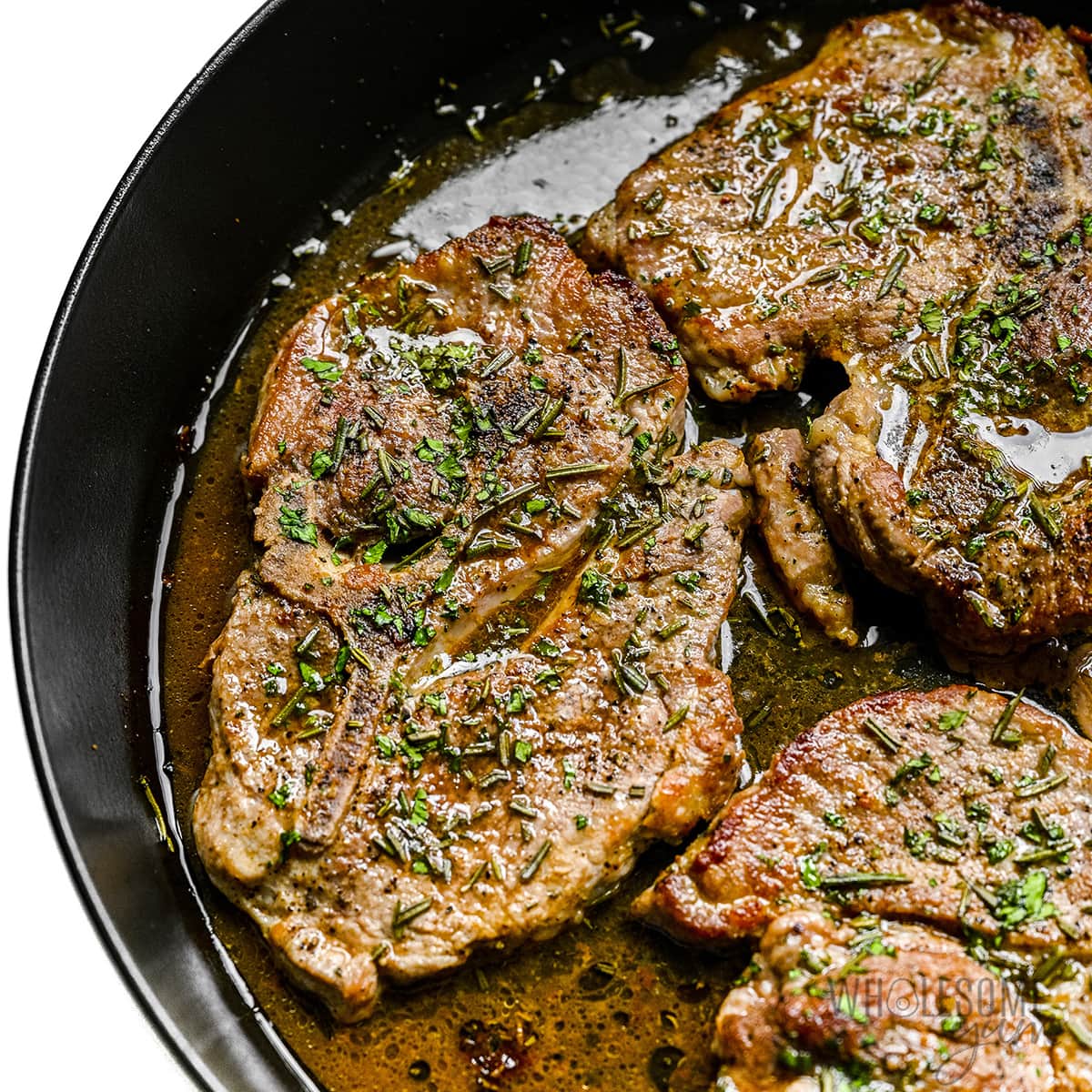 Pork steak recipe in cast iron skillet.