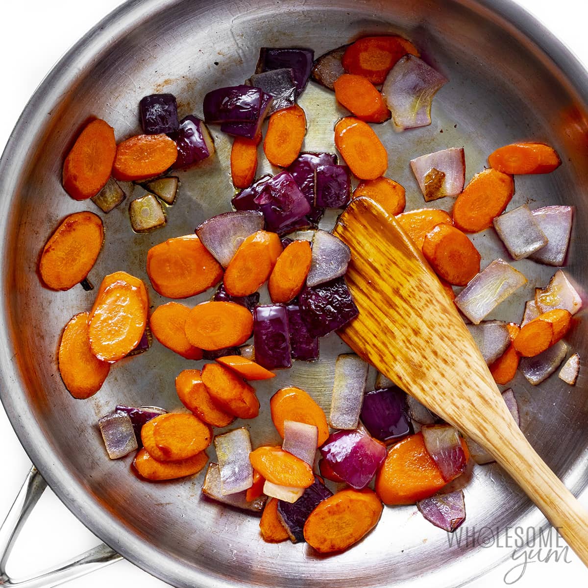 Carrots and onions in saute pan. 