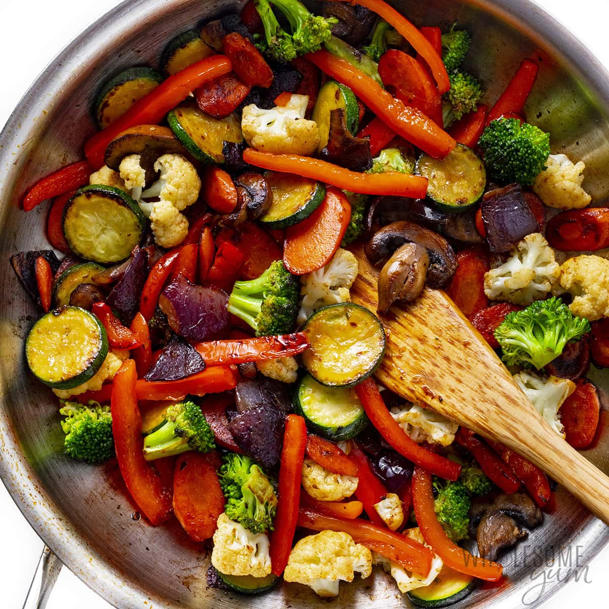 Bell peppers, broccoli, cauliflower, mushrooms, and zucchini added to saute pan. 