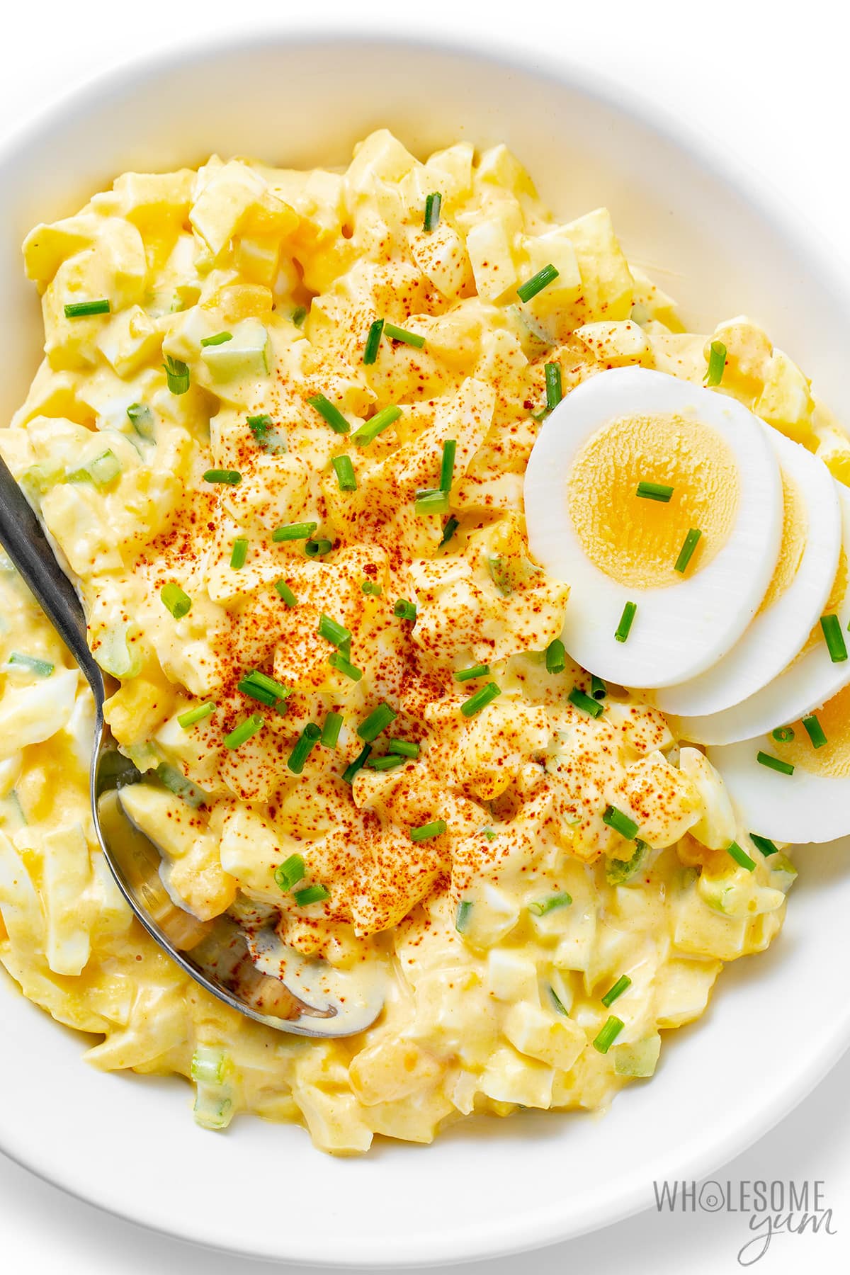 Easy egg salad in a bowl with a spoon.